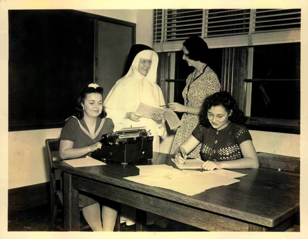Sister Francis Clare O'Brien teaches her Secretarial Science class to a group of students
